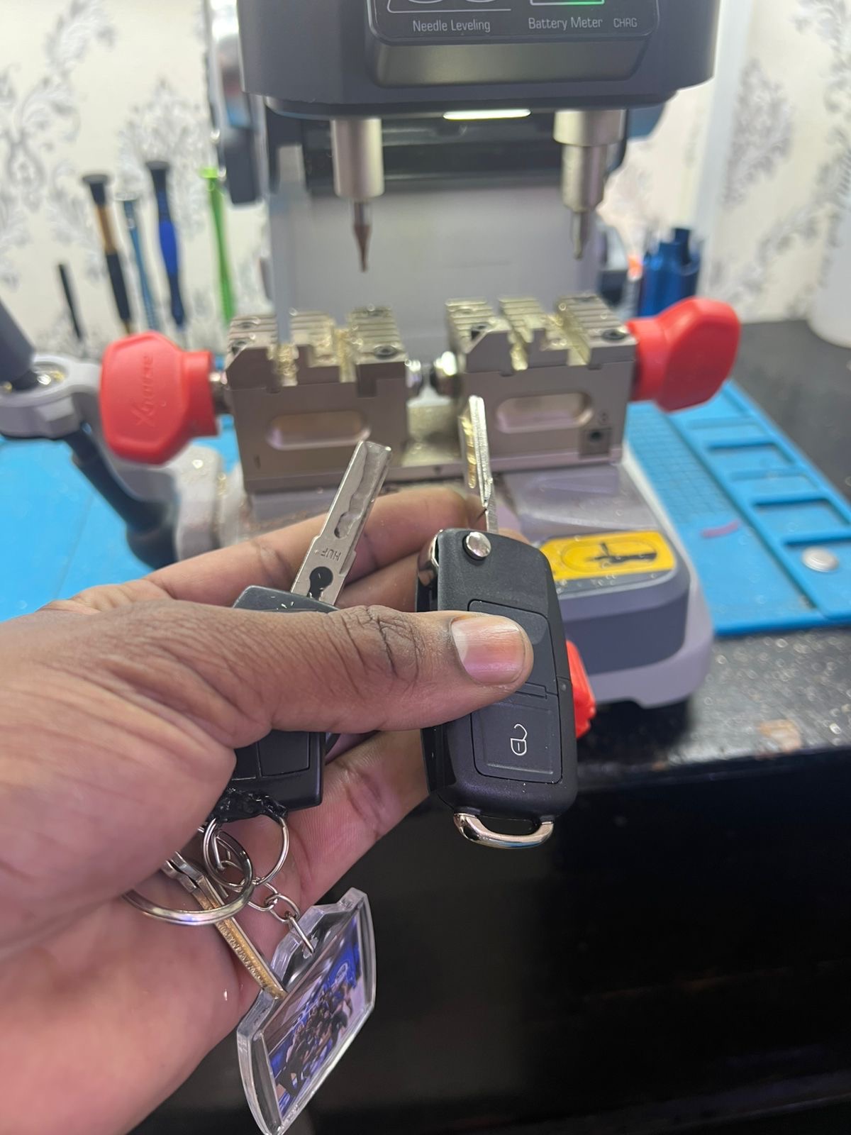 Máquina de corte de chaves na bancada da Locksmithcell com chave canivete automotiva